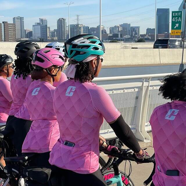 Female riders wearing breast cancer awareness Cliptn jerseys